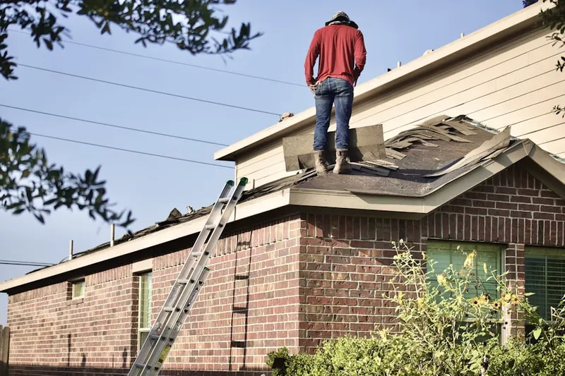 Professional roofer working on a residential roof in Huntington Hills